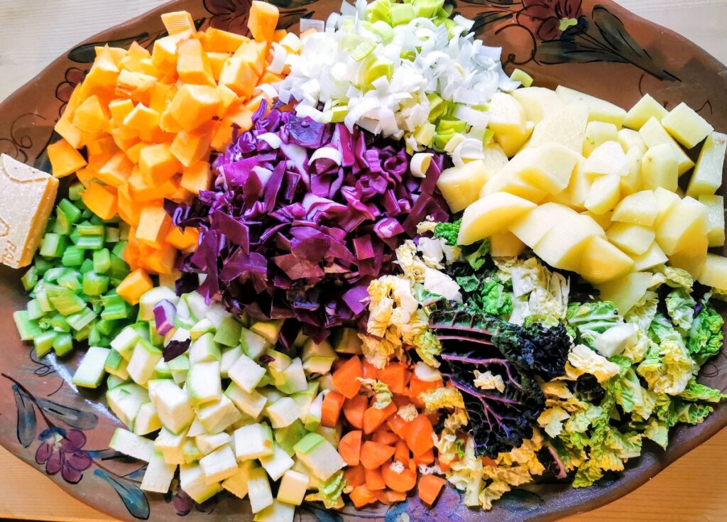 cleaned, chopped and sliced vegetables for minestrone on oval plate