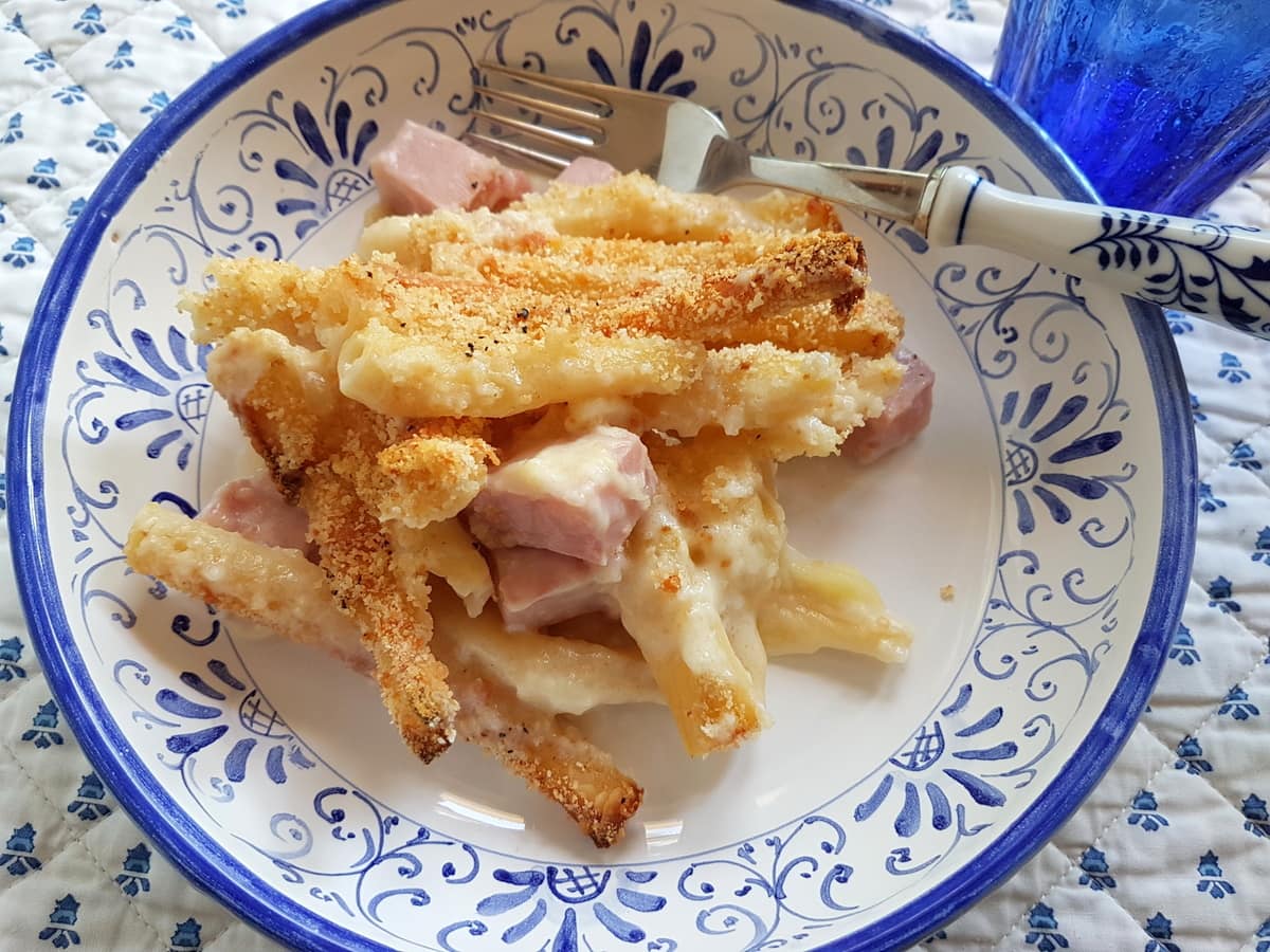 Baked ziti pasta on a plate with a fork.