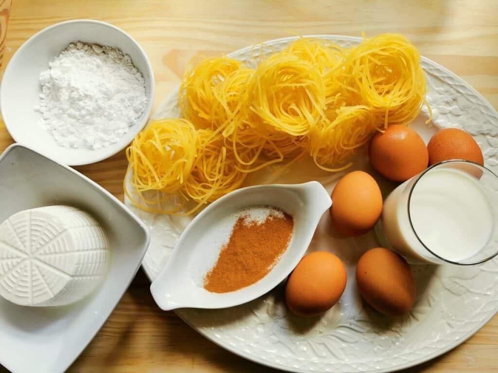 ingredients for Neapolitan ricotta and pasta pie on white plate