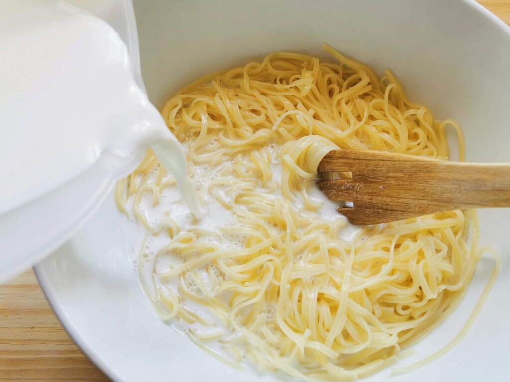 cooked pasta  in bowl with milk added