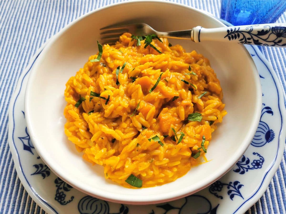 Neapolitan risotto-style pasta and pumpkin in white bowl.