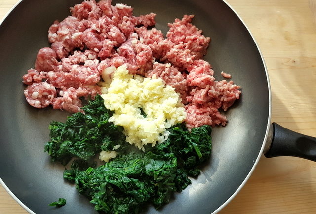 sausage meat, ground veal, cooked spinach and cooked onions in frying pan