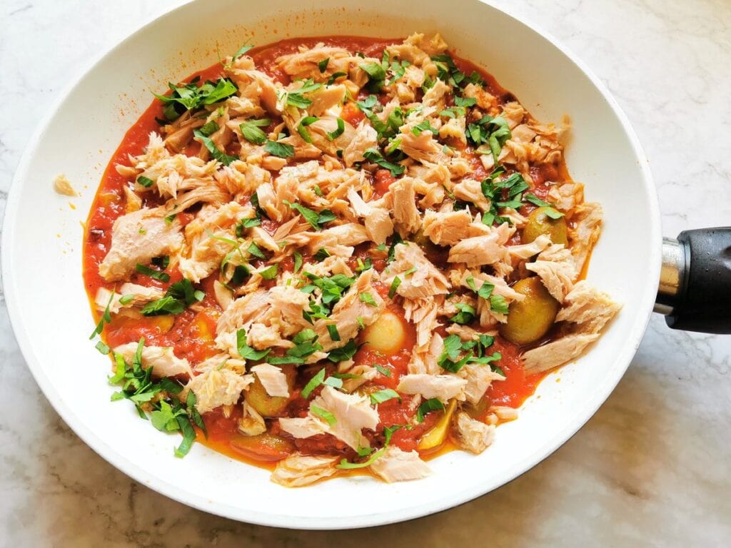 Chopped parsley and anchovies added to the tuna, olive and tomato sauce