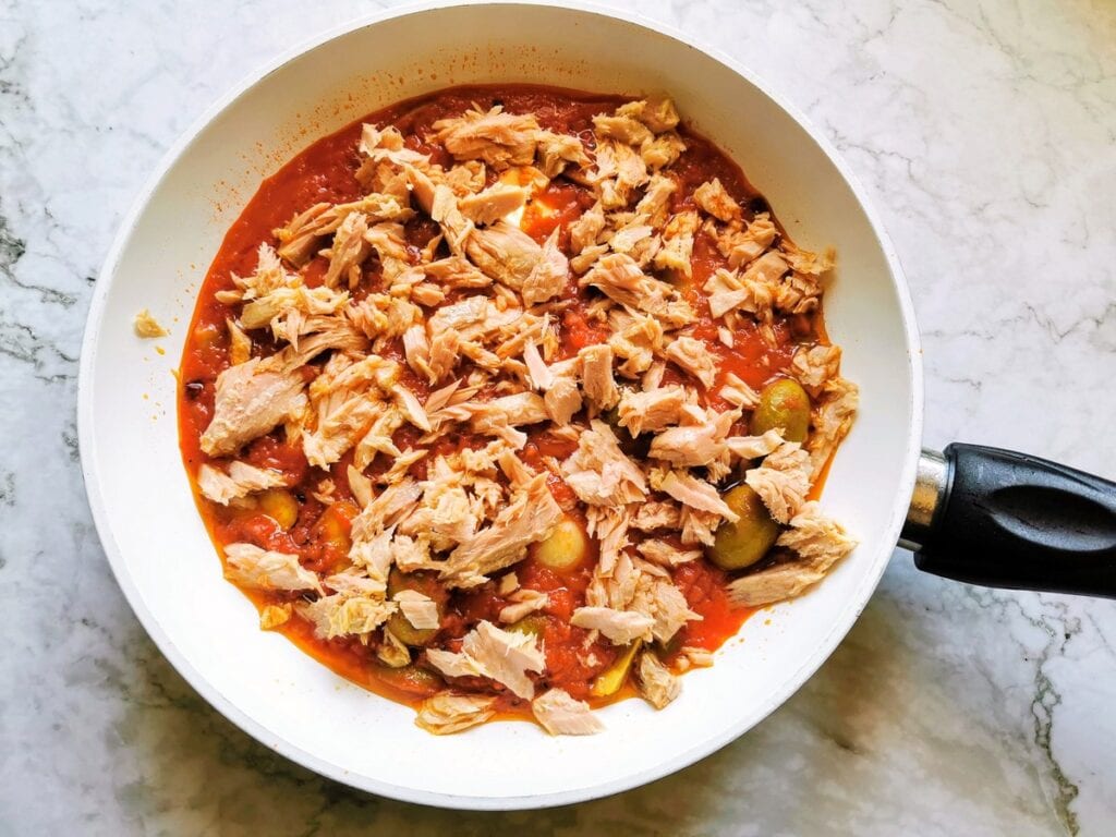 Drained and chopped tuna added to the pan with the tomato and olive sauce.