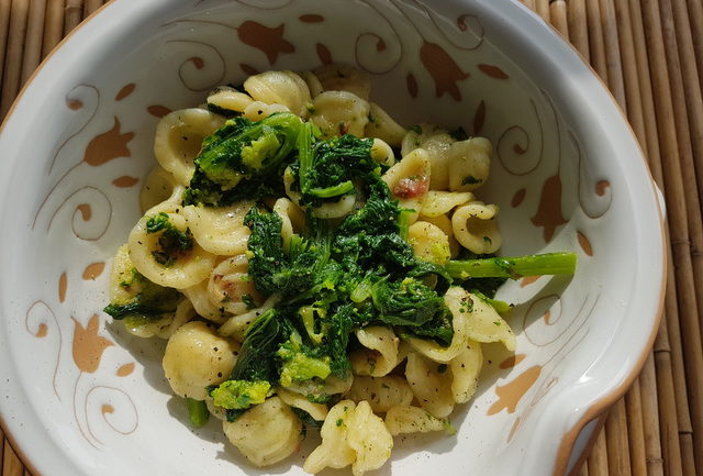 Orecchiette with Broccoli Rabe (rapini) in white terracotta bowl