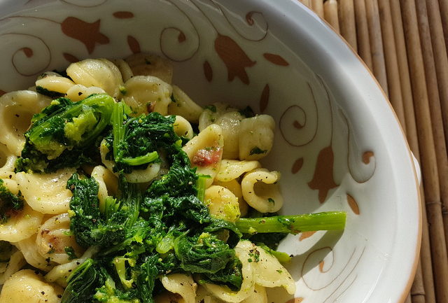 Close up orecchiette with Broccoli Rabe (rapini) in white terracotta bowl