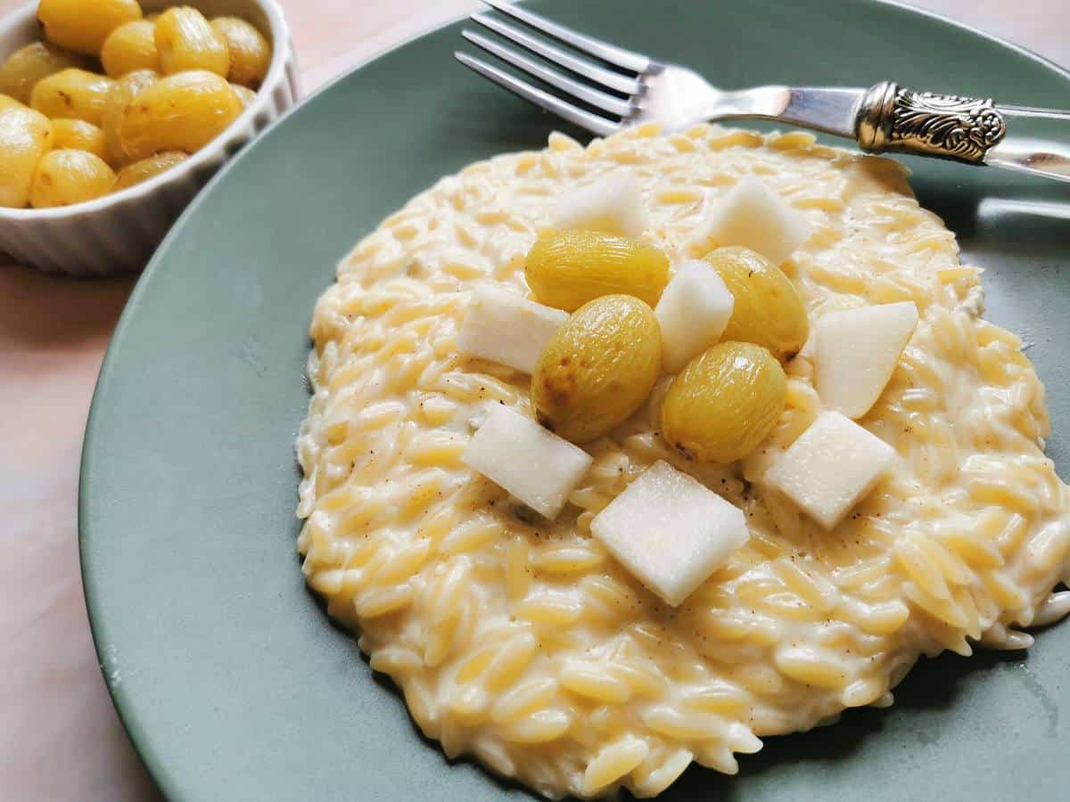 Orzo risotto with gorgonzola and topped with roasted grapes and fresh pear.