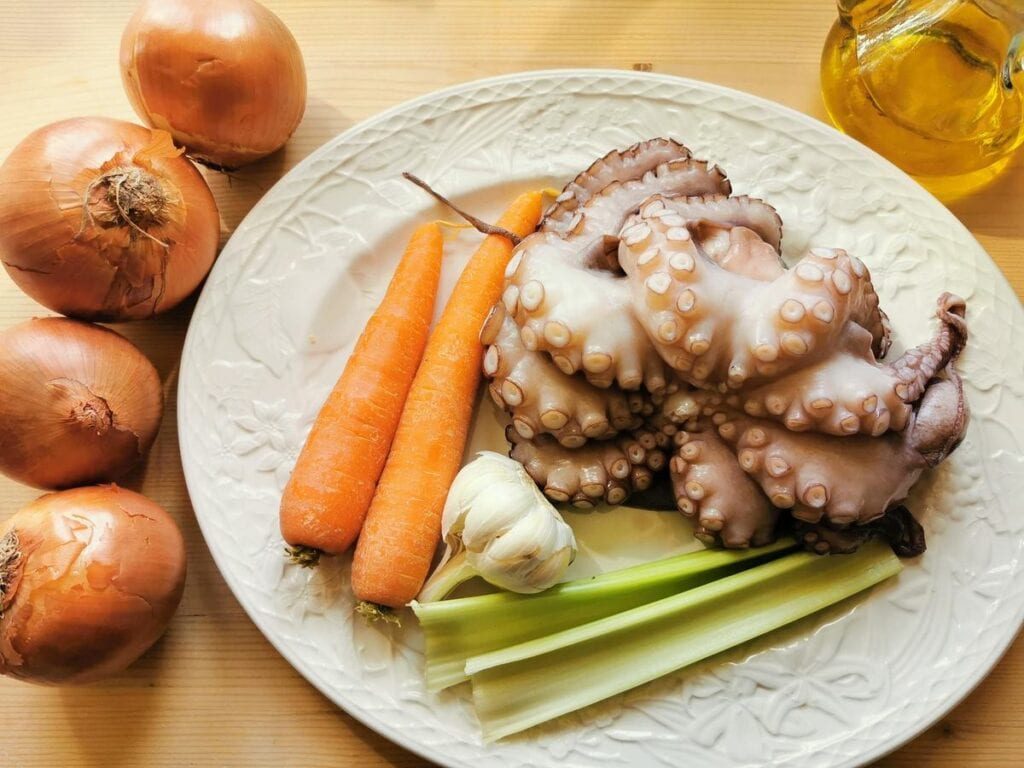 ingredients for octopus ragu on white plate