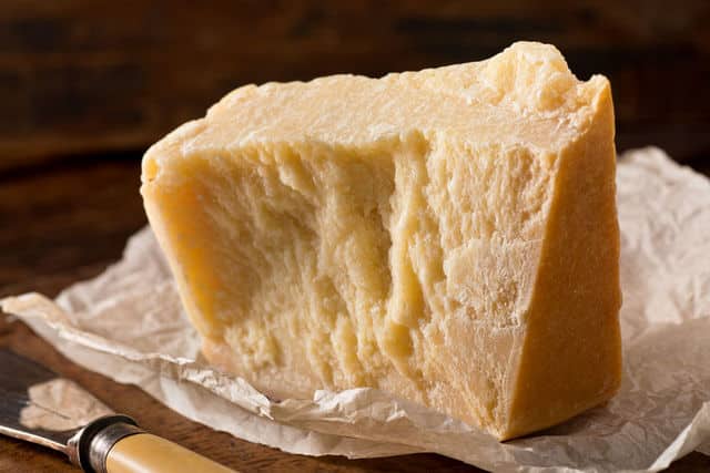 a piece of parmigiano reggiano on white paper