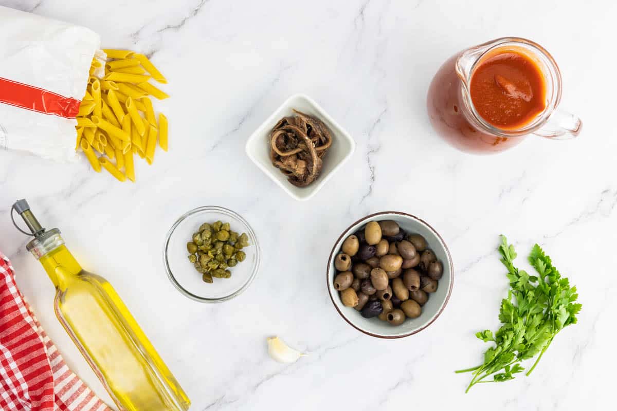 Ingredients for the Mediterranean pasta recipe portioned in bowls