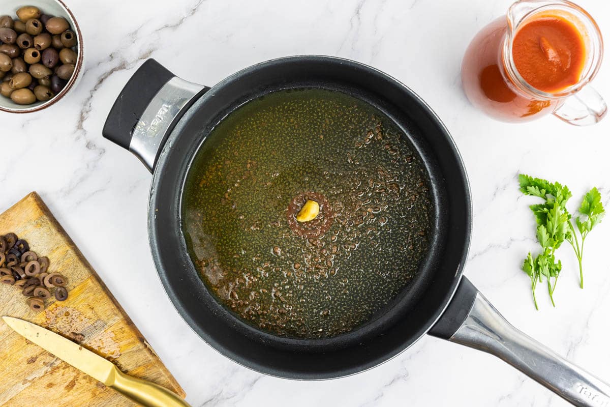 Anchovies added to the garlic and olive oil