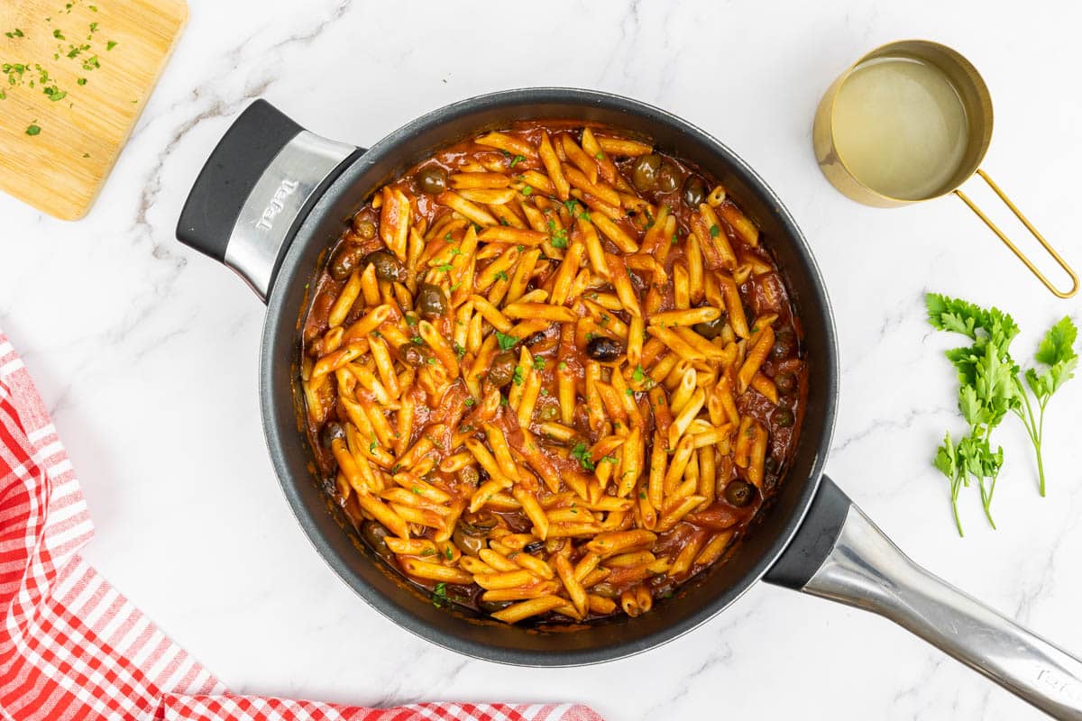 Pasta added to the Mediterranean sauce in a pan