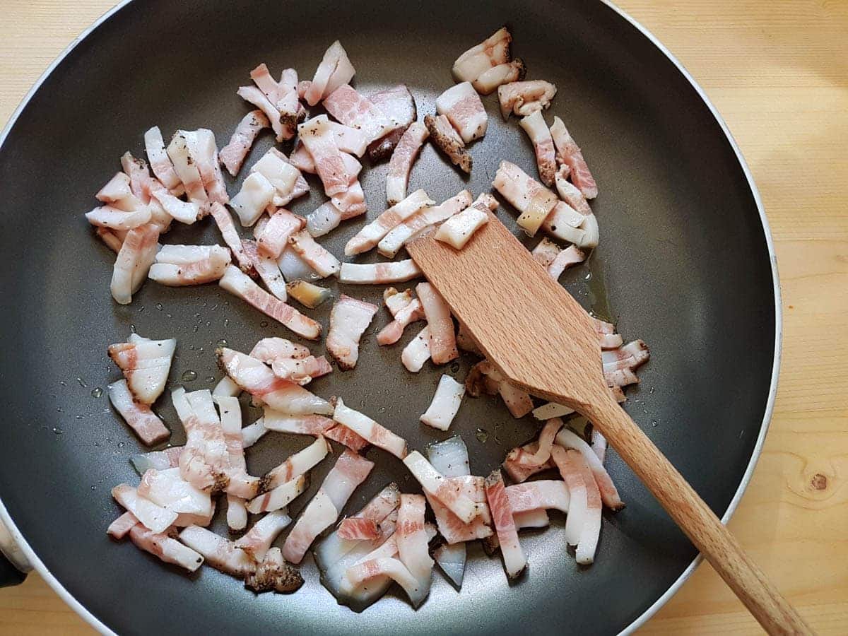 small slices of guanciale/ pork jowl in frying pan