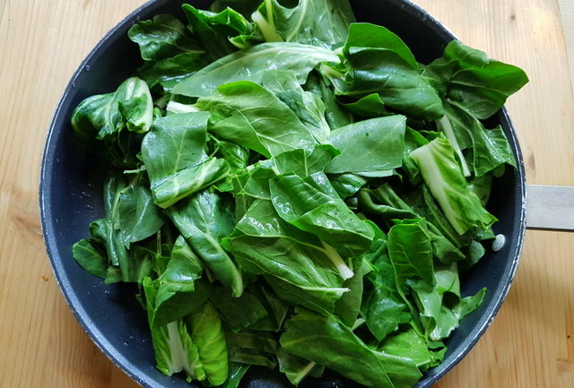 raw Swiss chard leaves in frying pan