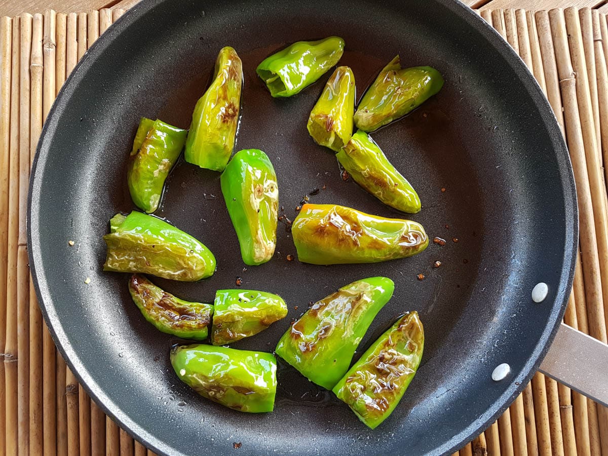 Friggitelli peppers being fried in a pan