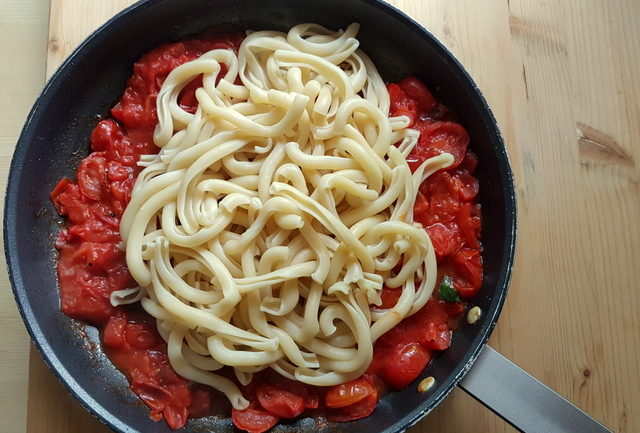Sicilian spaccatelle pasta with homemade tomato sauce in frying pan