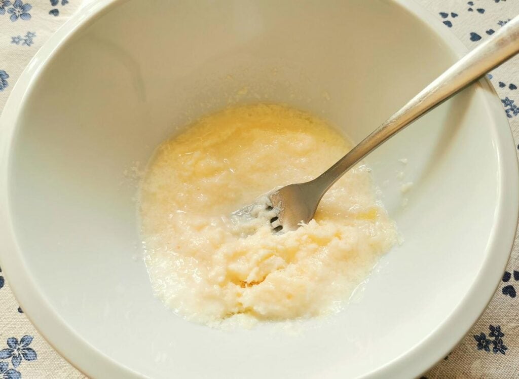 grated pecorino mixed with pasta cooking water in white bowl