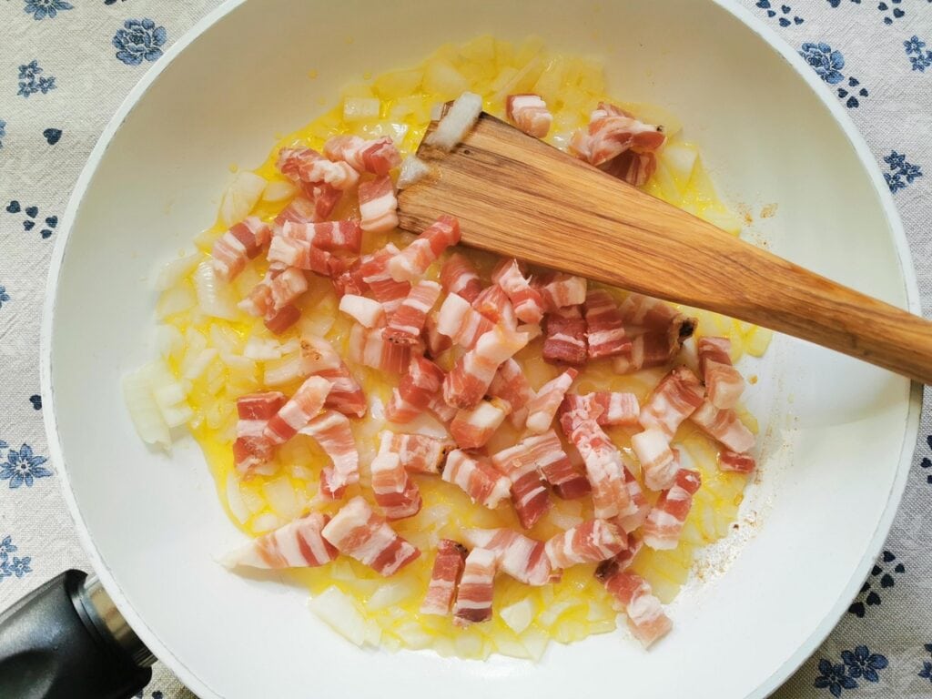 uncooked pancetta in pan with onion