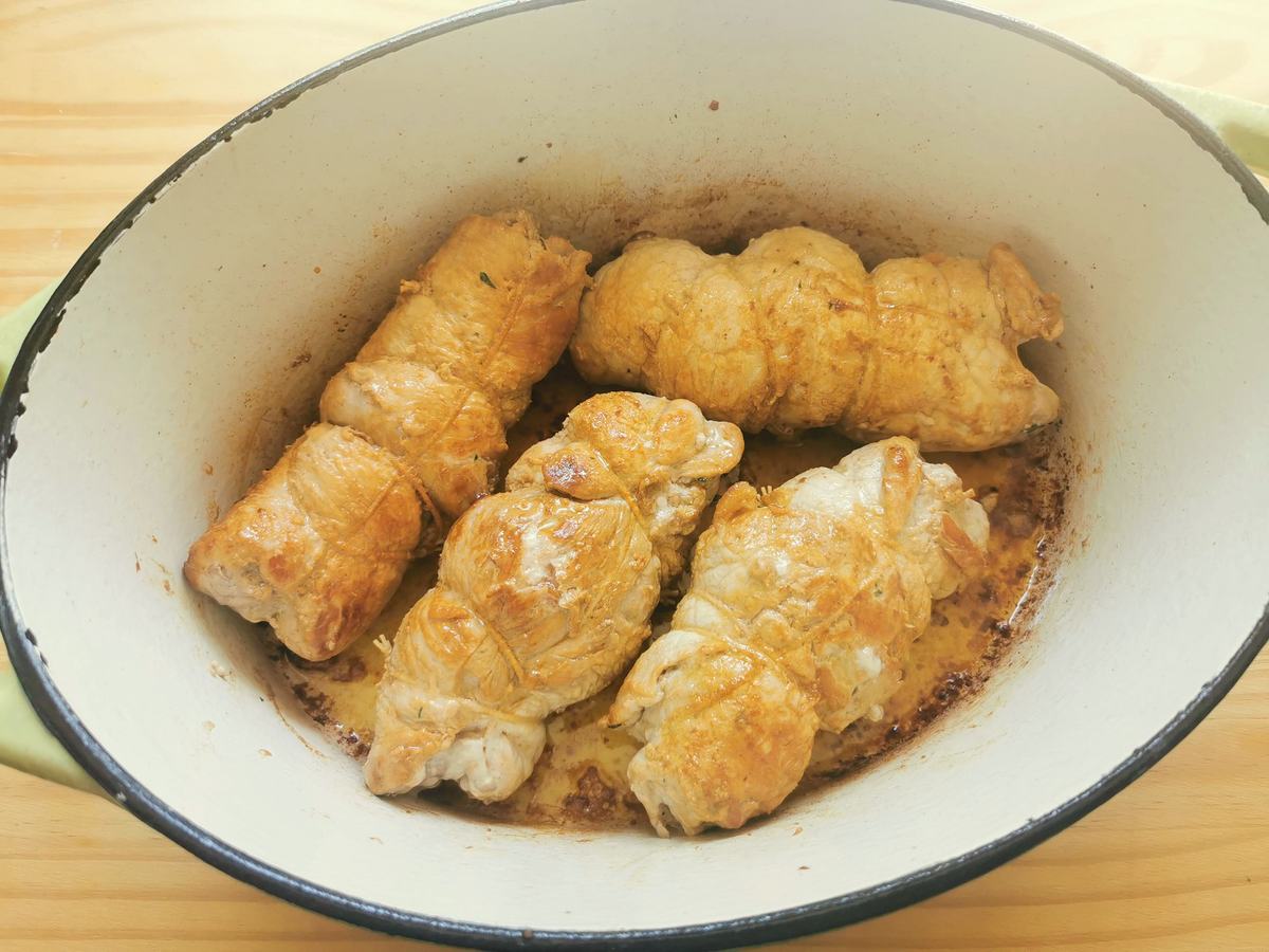 $ pork braciole (involtini) browning in Dutch oven.
