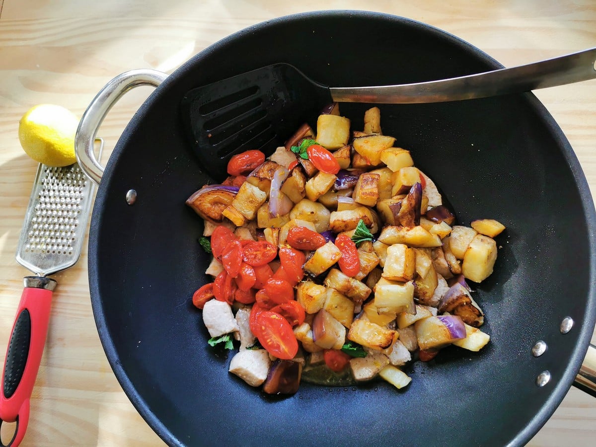 Swordfish and vegetables in a pan.