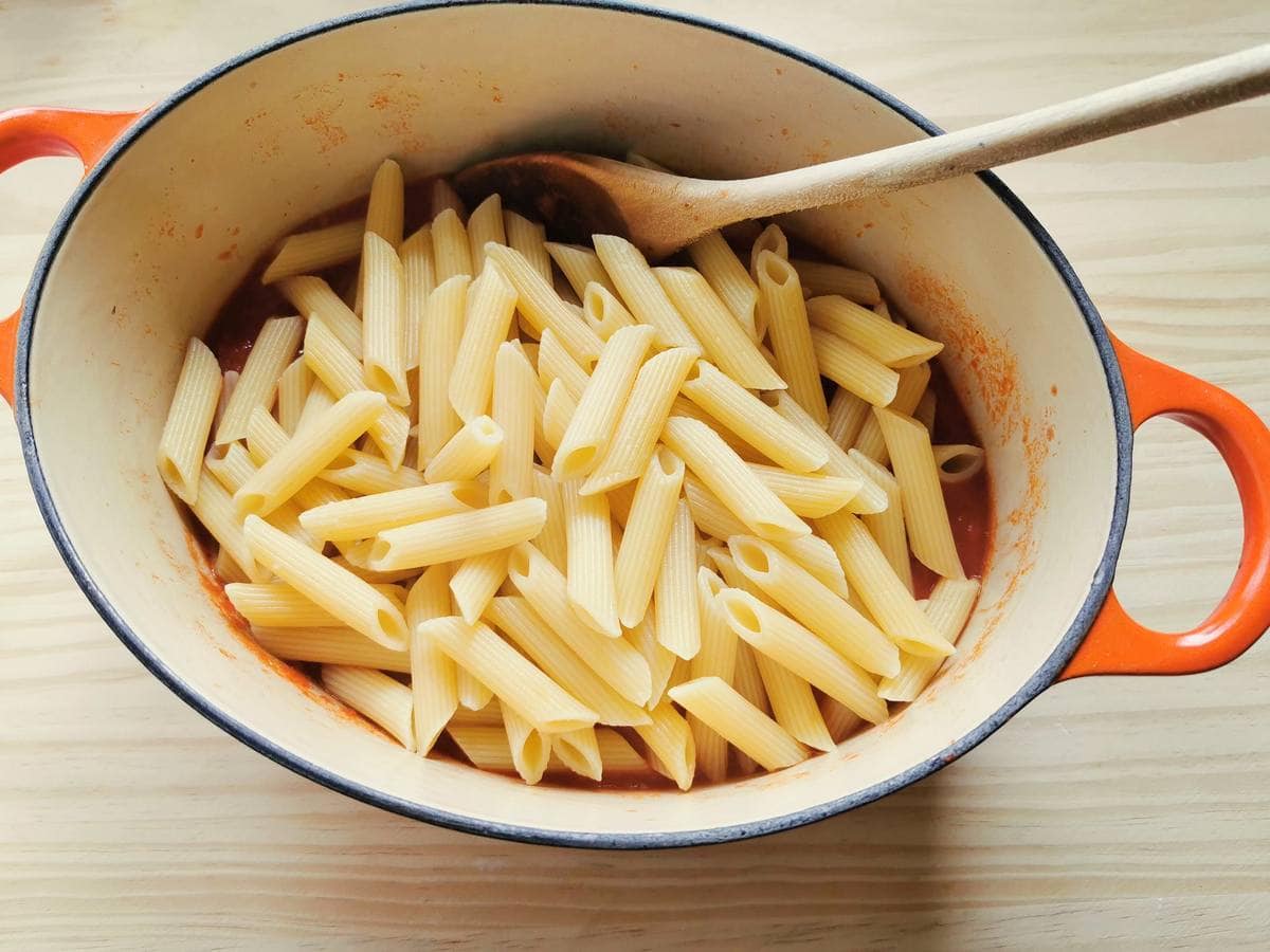 Cooked pasta in Dutch oven with allo scarpariello sauce.