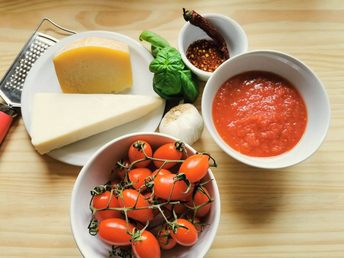 ingredients for Pasta tomato sauce allo scarpariello on wood work surface