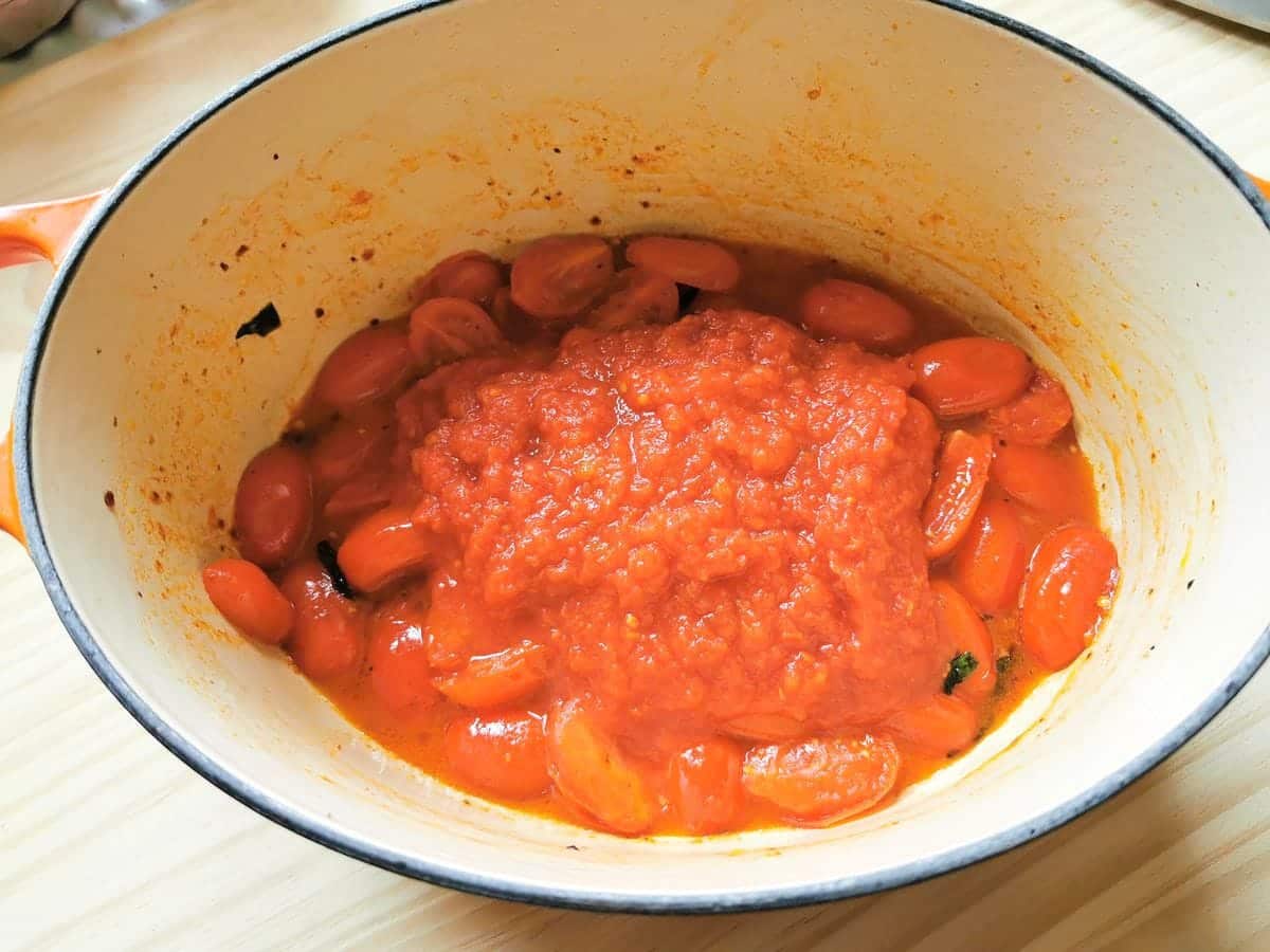 tomato passata added to Dutch oven with cooked tomato halves