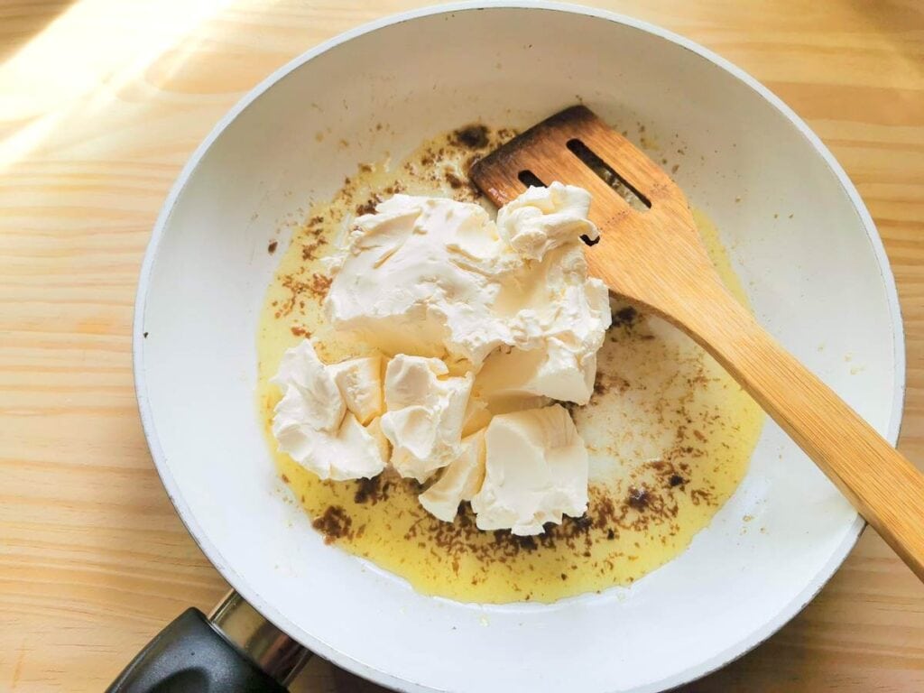 mascarpone in frying pan with anchovies and olive oil