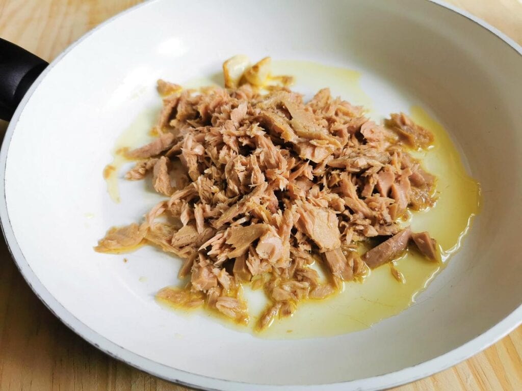 canned tuna fillet in frying pan with olive oil