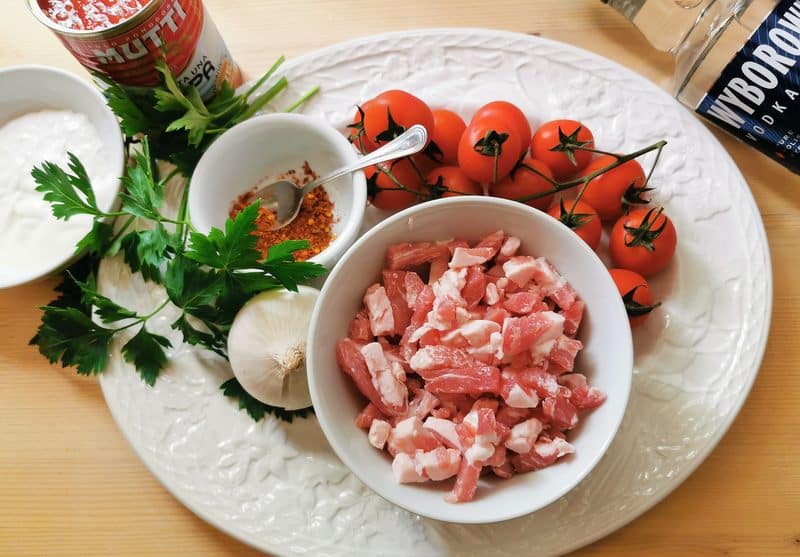 ingredients for penne alla vodka on white plate