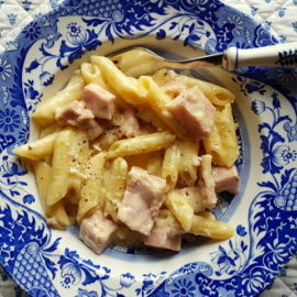 Penne pasta alla Valdostana in a blue and white bowl