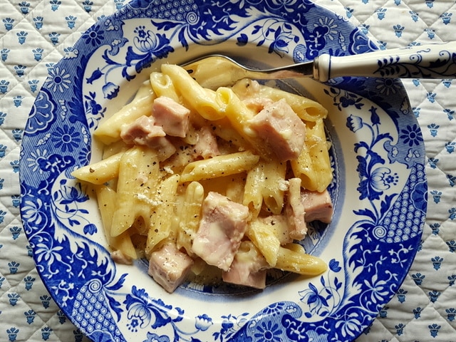 Penne pasta alla Valdostana in a blue and white bowl