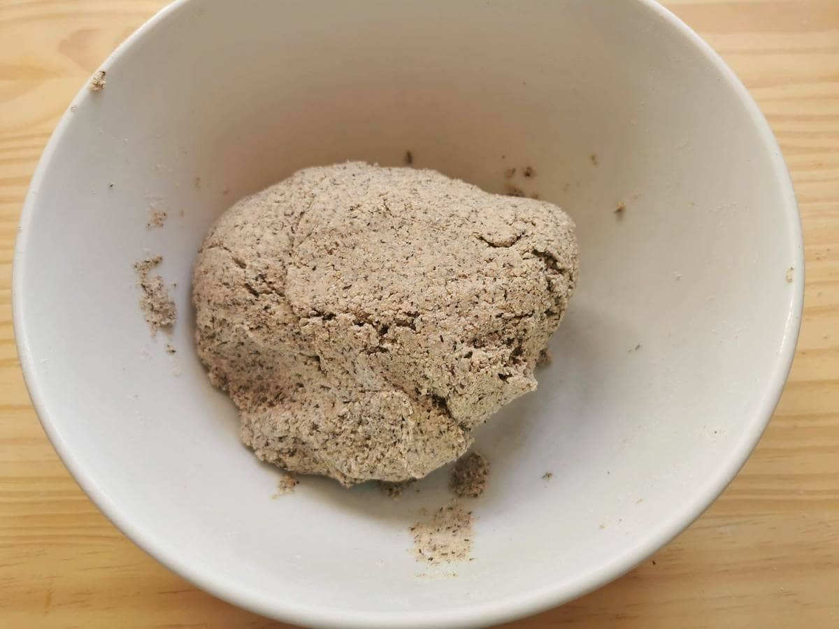 A ball of pizzoccheri buckwheat pasta dough in a large bowl