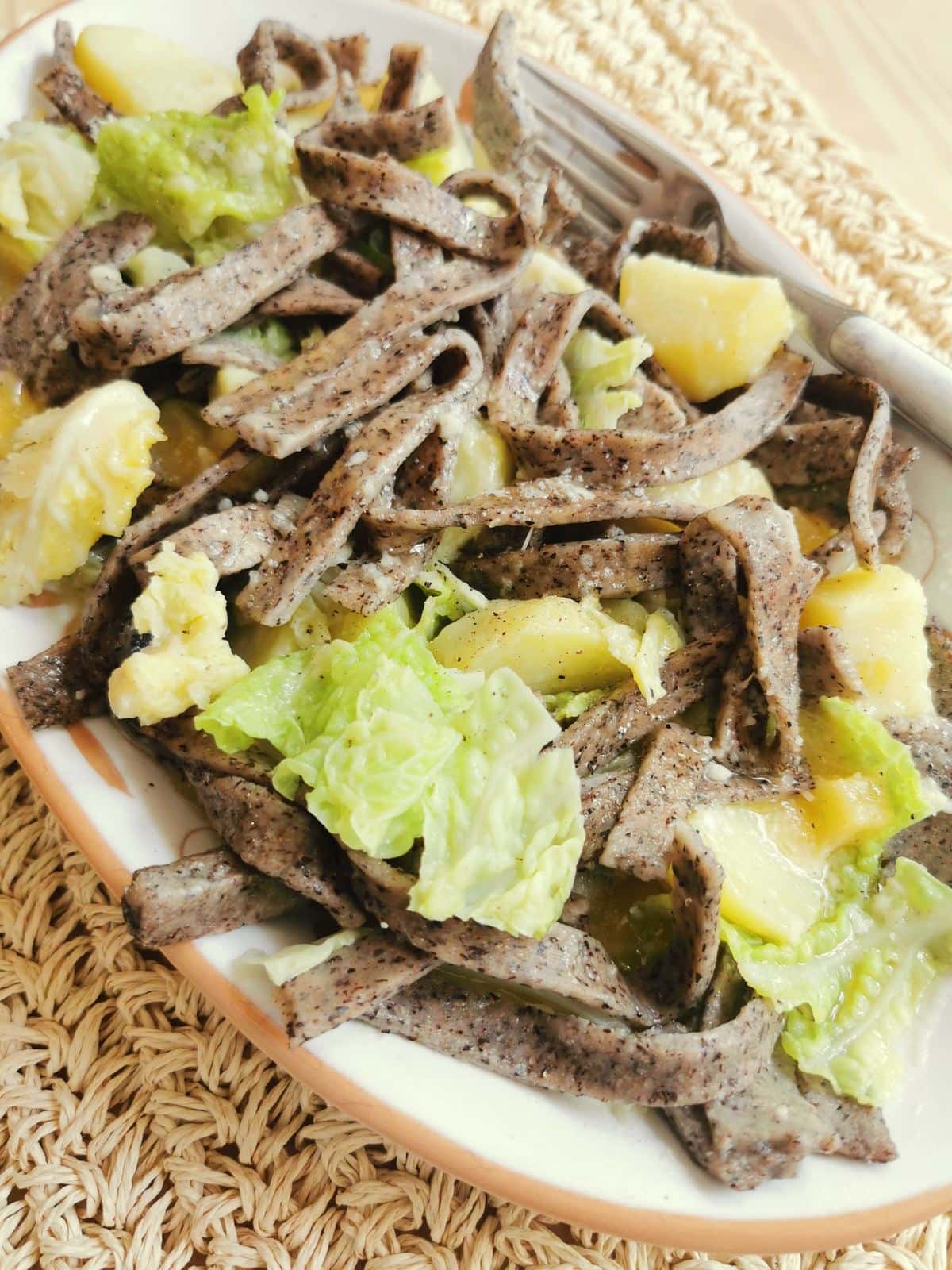 Pizzoccheri alla Valtellinese, buckwheat pasta with potatoes, savoy cabbage, cheese and butter.