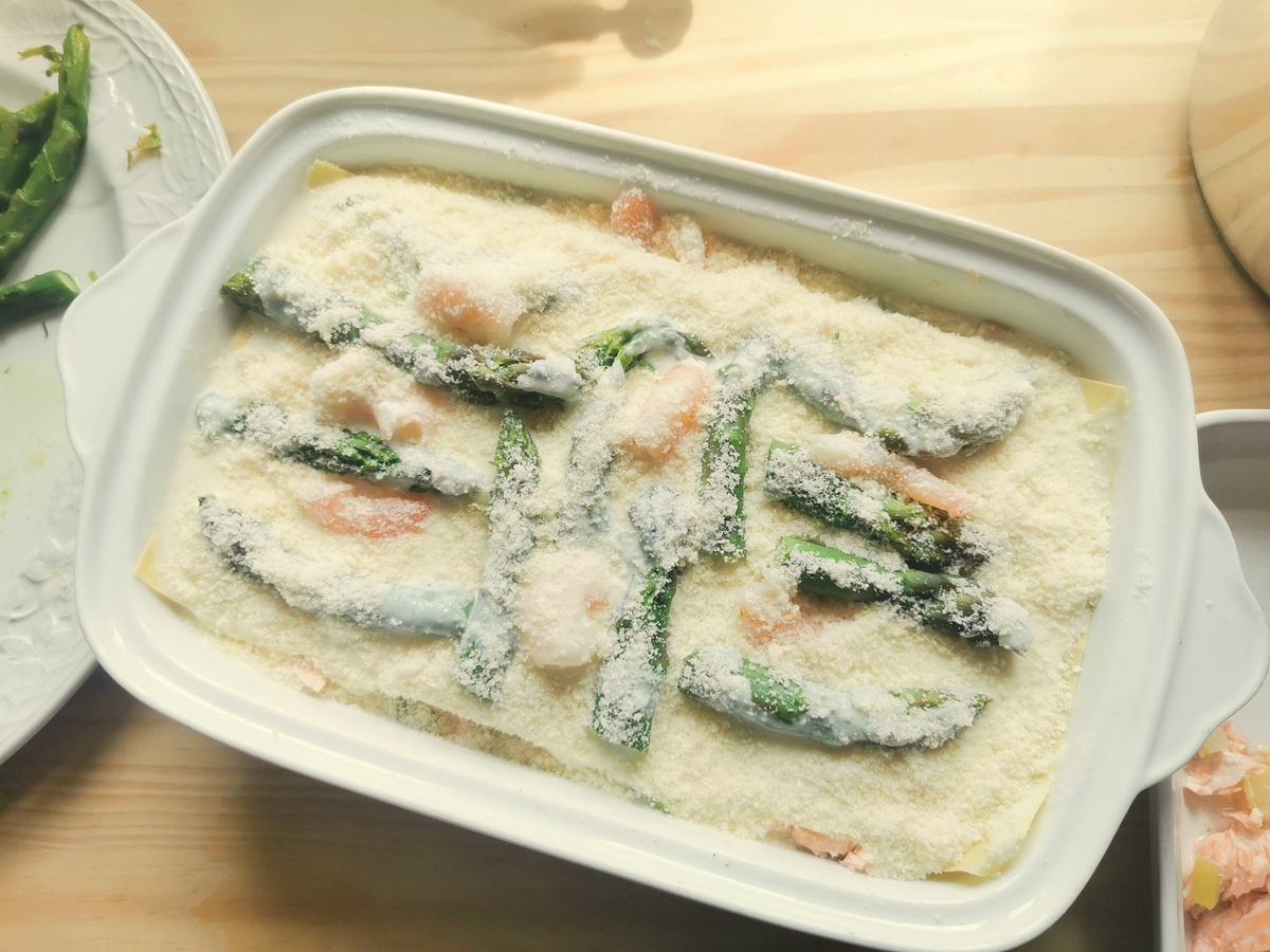 Poached salmon and asparagus lasagne al forno ready to go in the oven.