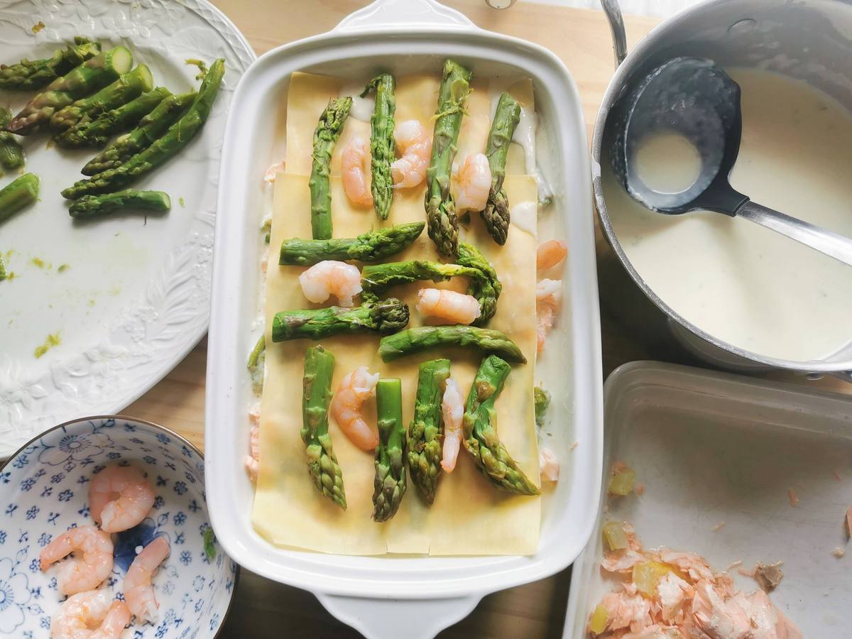 Top layer of pasta sheets for salmon and asparagus lasagna with shrimps and asparagus spears.