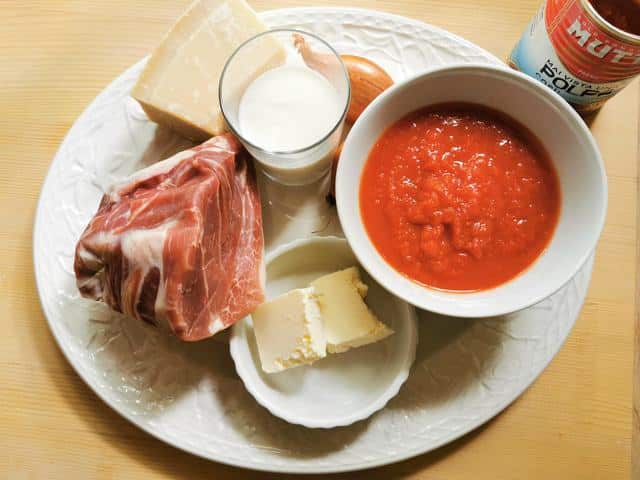 ingredients for prosciutto ragu on white plate