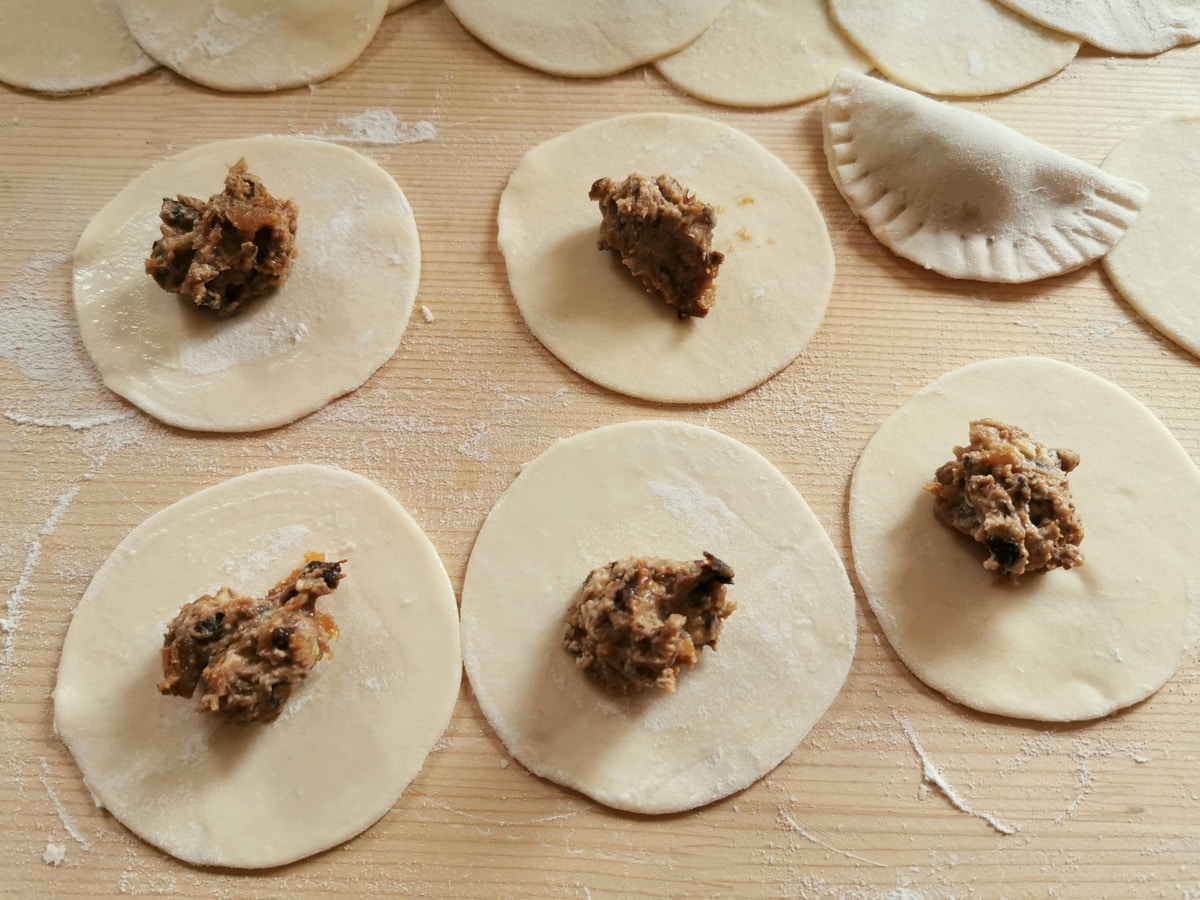 Adding the filling to the ravioli dough.