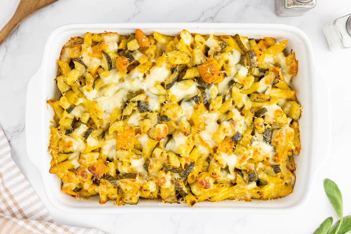 Golden brown pumpkin pasta bake in a baking dish