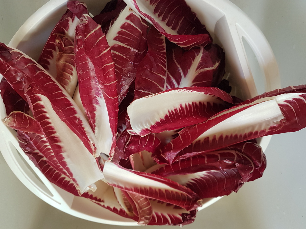 Washed radicchio leaves in colander.