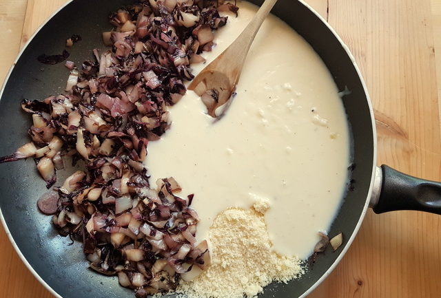 cooked radicchio, bechamel and grated cheese in frying pan