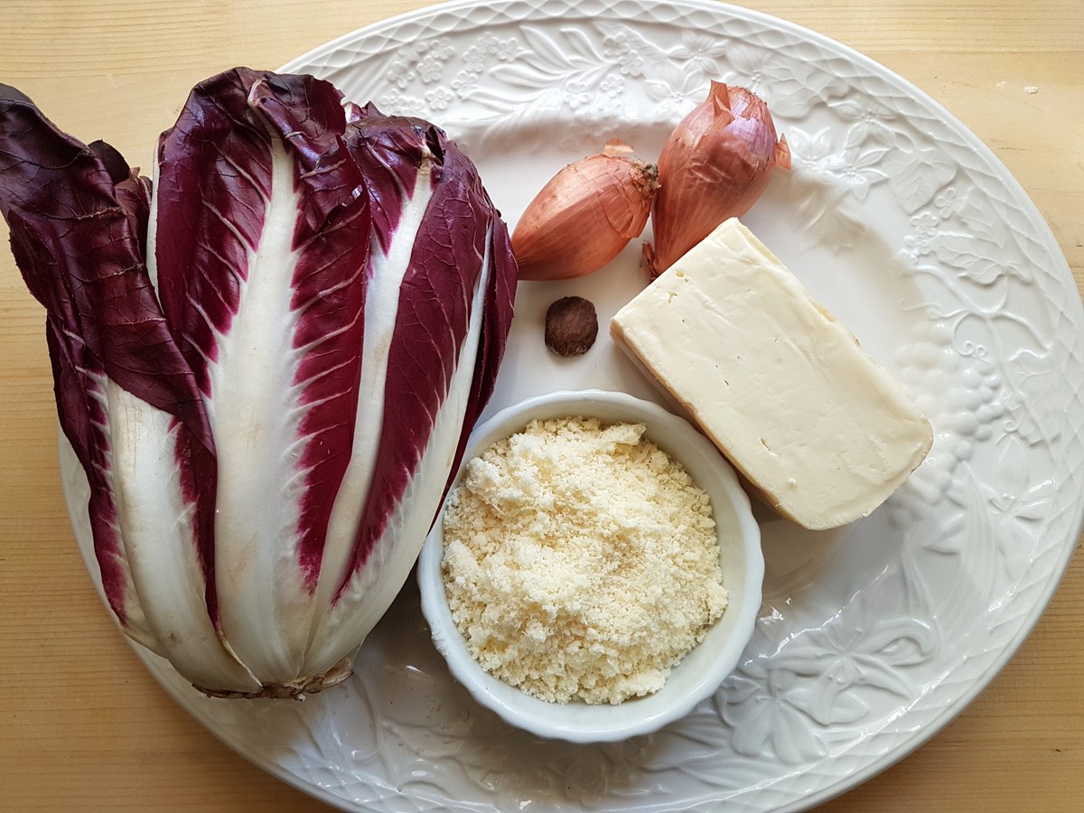 Ingredients for radicchio lasagna filling on white plate.