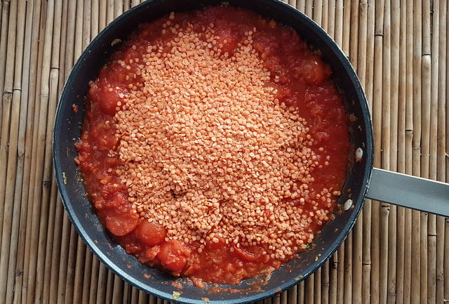 Red lentil ragu with whole-wheat pasta sauce ingredients in frying pan