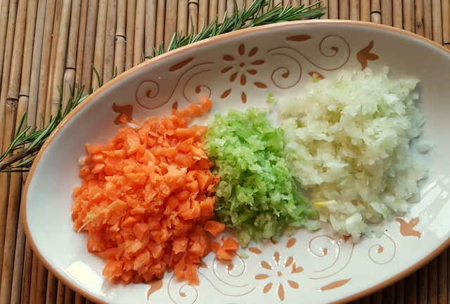 Red lentil ragu with whole-wheat pasta chopped vegetables in white and terracotta plate