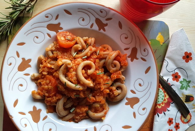 Red lentil ragu with whole-wheat pasta in white and terracotta bowl