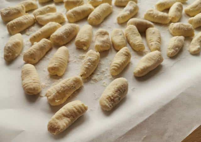 ricotta gnocchi on floured baking paper ready to be cooked