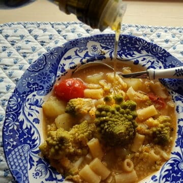 Romanesco broccoli pasta soup in blue and white soup bowl