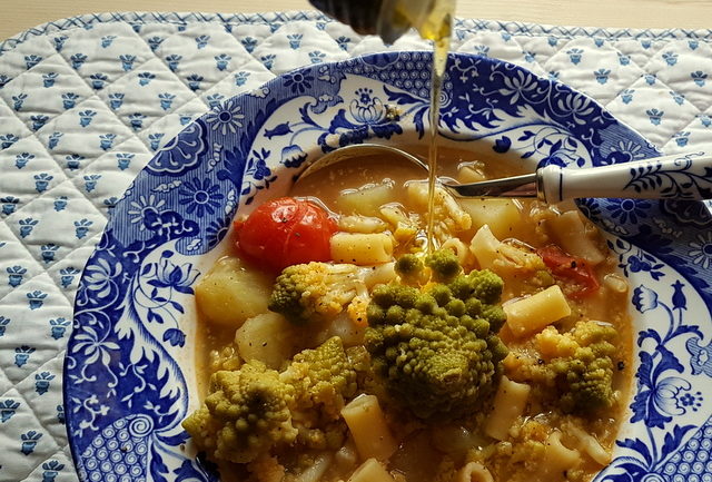 Romanesco broccoli pasta soup in blue and white soup bowl