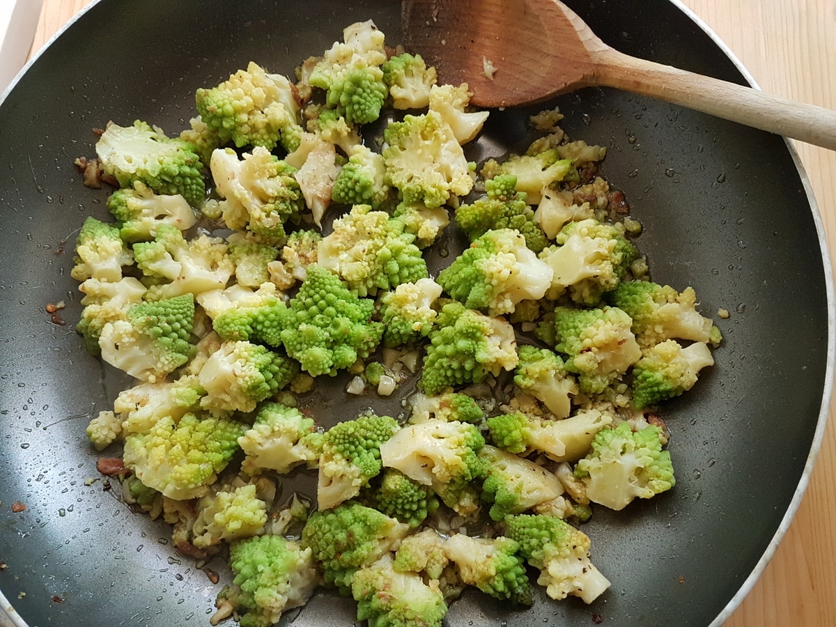 Romanesco broccoli cooking in a pan.