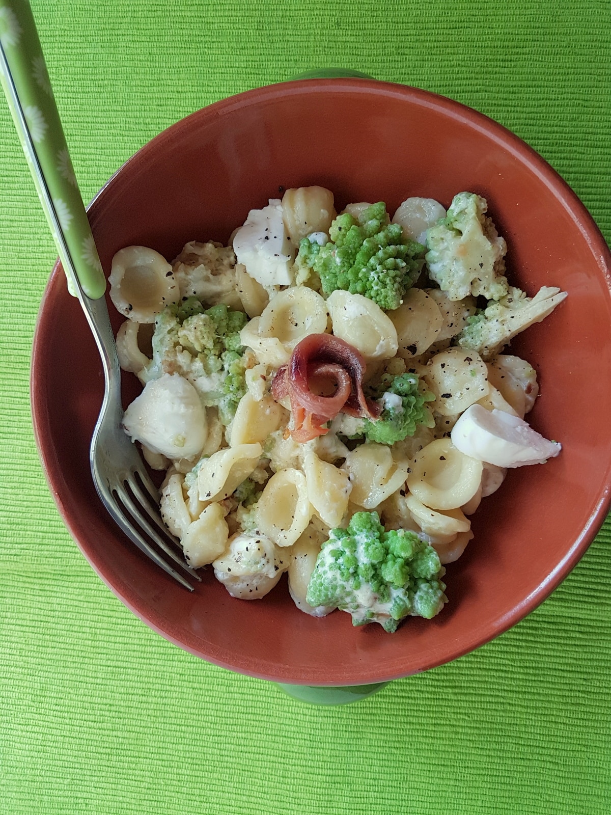 Orecchiette pasta with Romanesco broccoli recipe in a bowl with a fork.